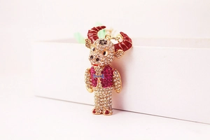Detailed macro of rhinestone encrusted bull keychain with red horns and blue bow tie