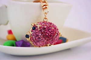 Detailed close-up of pink crystal pig keychain with gold-plated metal base and ring