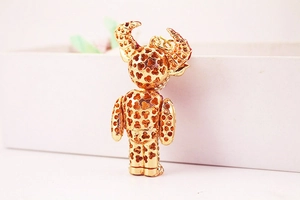 Macro view of the back of a gold ox bear keychain with hollow clover leaf pattern detail