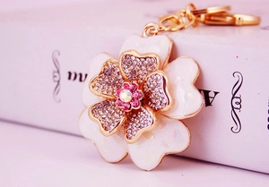 Macro view of shell flower keychain with pink rhinestones and gold plating on petals