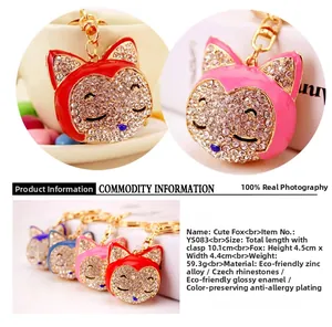 Detailed close-up showing rhinestone fox keychain size, weight and alloy material details
