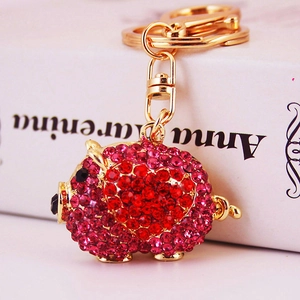 Cute pink rhinestone pig keychain with golden alloy base and sparkling heart pattern