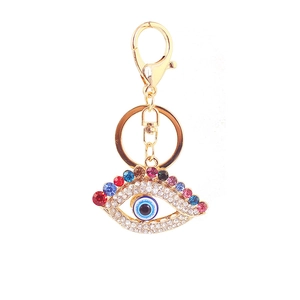 Détail du fermoir mousqueton doré et breloque œil porte-bonheur avec strass colorés