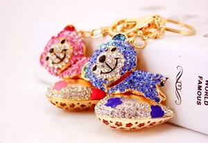 Detail of pink and blue crystal teddy bear keychains with shimmering heart pendants