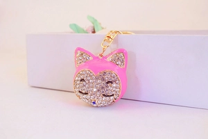 Close-up of pink fox keychain with sparkling white rhinestones and gold-tone metal hook