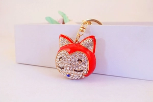 Close-up of red enamel fox keychain with sparkling rhinestones and golden lobster clasp