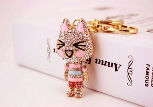 Detailed view of cat keychain with white and pink rhinestones on gold metal plating