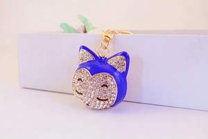 Detailed view of fox head keychain with navy blue enamel and sparkling white rhinestones