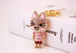 Detailed macro view of a sparkling rhinestone kitten keychain with gold metal clasp