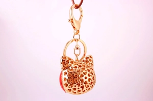 Detail of rose gold hollow fox charm with heart patterns and lobster clasp for bag