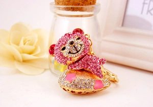Close-up of pink crystal bear keychain with gold heart base and lobster clasp detail
