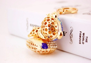Detail showing the hollow golden metal ball pendant with blue and white crystals decoration