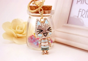 Detailed close-up of a sparkling rhinestone kitten keychain with gold metal lobster clasp