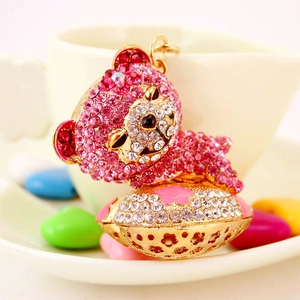 Sparkly pink crystal teddy bear keychain with gold hardware and rhinestone star charms