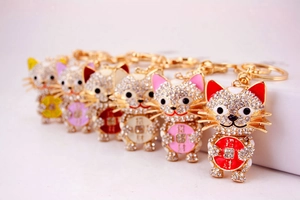 Close-up of sparkling crystal-studded Maneki Neko keychains in six vibrant colors