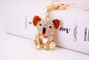 Close-up of a gold koala keychain with sparkling crystals and detailed rhinestone inlay