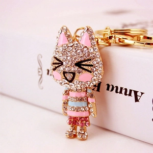 Sparkly rhinestone-studded cat keychain with pink enamel details and gold plating
