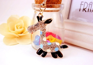 Détail du porte-clés girafe serti de strass avec des taches colorées en émail