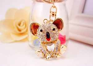 Detailed macro view of crystal-encrusted koala keychain with polished gold hardware