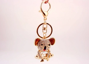 Detailed close-up of a sparkling crystal-encrusted koala keychain with golden finish