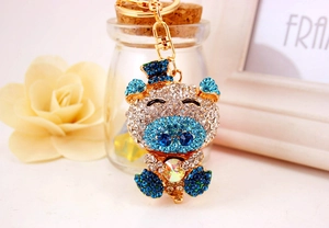 Detailed view of a crystal pig keychain featuring sparkling blue rhinestones and gold alloy