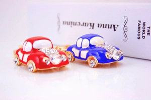 Detailed macro view of red and blue vintage car keychains with sparkling rhinestones