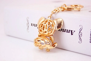 Close-up of golden hollowed animal keychain with intricate geometric mesh details