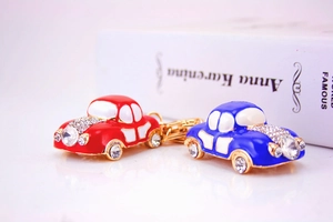 Macro shot of red and blue cartoon car keychains with sparkling crystal rhinestones
