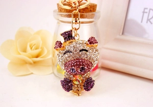 Detail of cute crystal pig keychain with pink rhinestones and golden lobster clasp