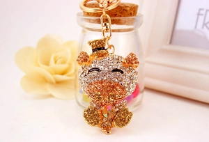 Detail of cute crystal pig keychain with gold alloy finish and sparkling rhinestones