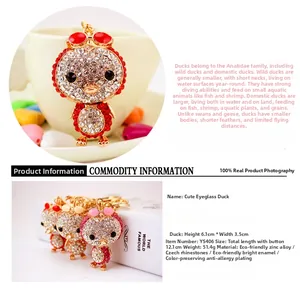Detail view of rhinestone-studded duck keychain showing dimensions and color options