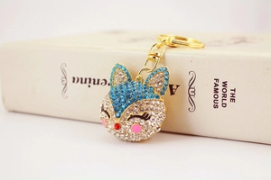 Detailed close-up of a gold fox keychain with sparkling blue rhinestones and lobster clasp