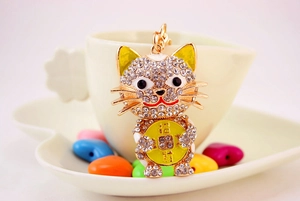 Close-up of sparkling crystal encrusted lucky cat keychain with golden Lucky coin