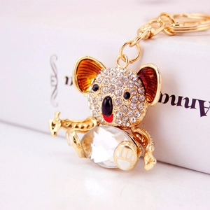 Cute gold koala keychain with white crystals and large multifaceted gemstone pendant