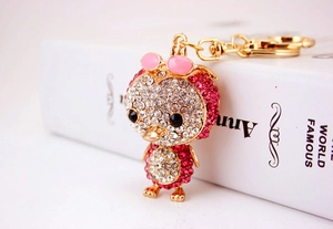 Detail of a sparkling duck keychain with pink sunglasses and inlaid rhinestones