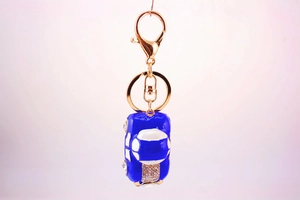 Detail of blue rhinestone car keychain with gold lobster clasp for handbags