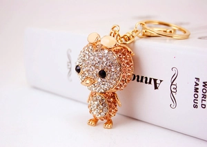 Detailed close-up of a crystal-encrusted duck keychain with golden alloy finish
