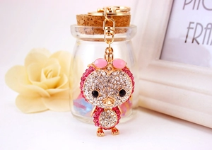 Close-up of sparkling pink rhinestone duck keychain with gold alloy lobster clasp detail