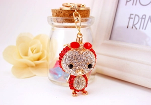 Close-up of sparkling rhinestone-encrusted duck keychain with red sunglasses and lobster clasp