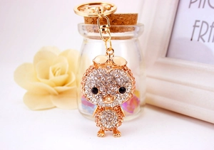 Detail of sparkling rhinestone duck keychain with gold plating and luxury gift setting