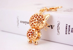 Detail of golden cat keychain with hollow heart pattern and crystal diamond embellishments
