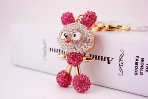 Detail of pink crystal encrusted rabbit keychain with gold plating and rhinestones