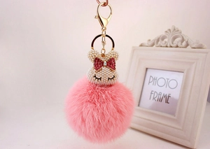 Porte-clés lapin en peluche rose avec tête sertie de perles et nœud en strass rouge