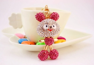 Macro detail of a sparkling pink crystal rabbit keychain with gold plating and lobster clasp