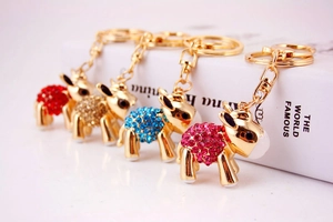 Detailed close-up of four colorful crystal donkey keychains with rhinestones and lobster clasps