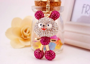Close-up of sparkling rose red rhinestone encrusted mouse keychain with gold ring