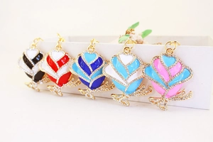 Detailed macro of crystal rhinestone rose flower pendants in five assorted vibrant colors