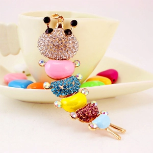 Colorful caterpillar keychain with sparkling rhinestones and gold alloy on a white cup