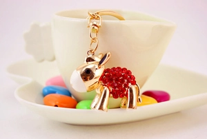Detailed close-up of golden donkey keychain with sparkling red rhinestone embellishments