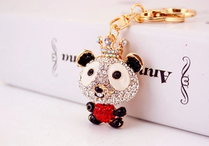 Detailed macro view of the sparkling rhinestone panda keychain with a golden crown